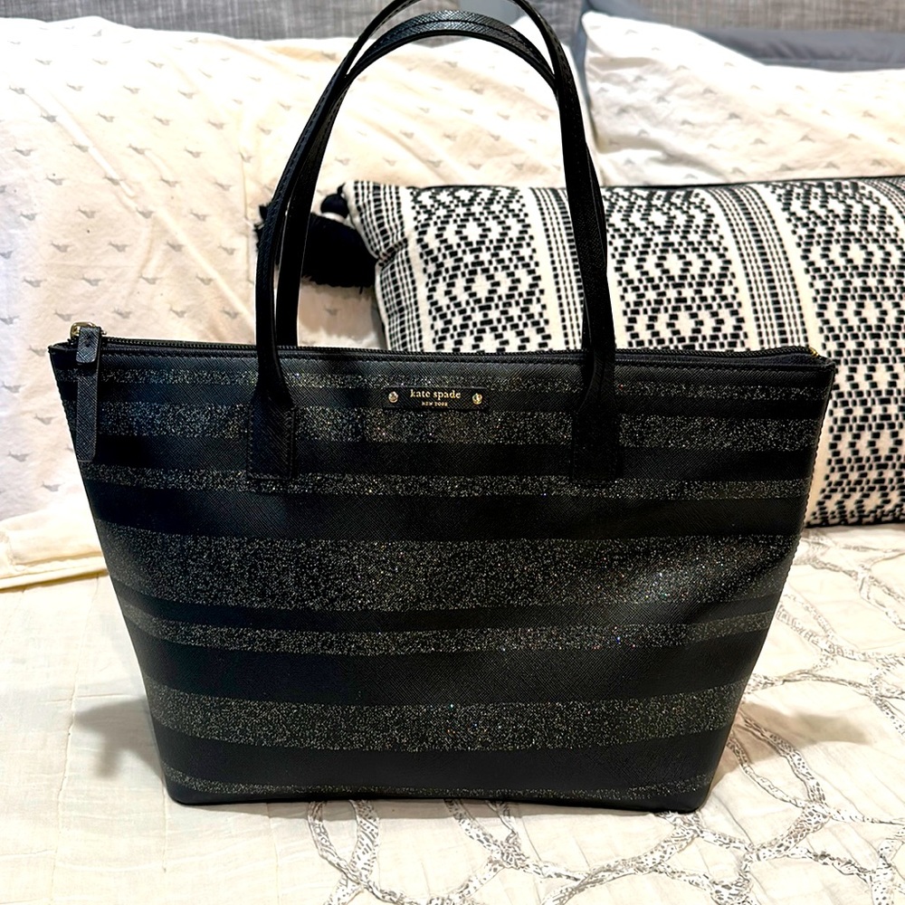 Black and silver Kate spade shoulder bag. About 10x12x5. Used a handful of times